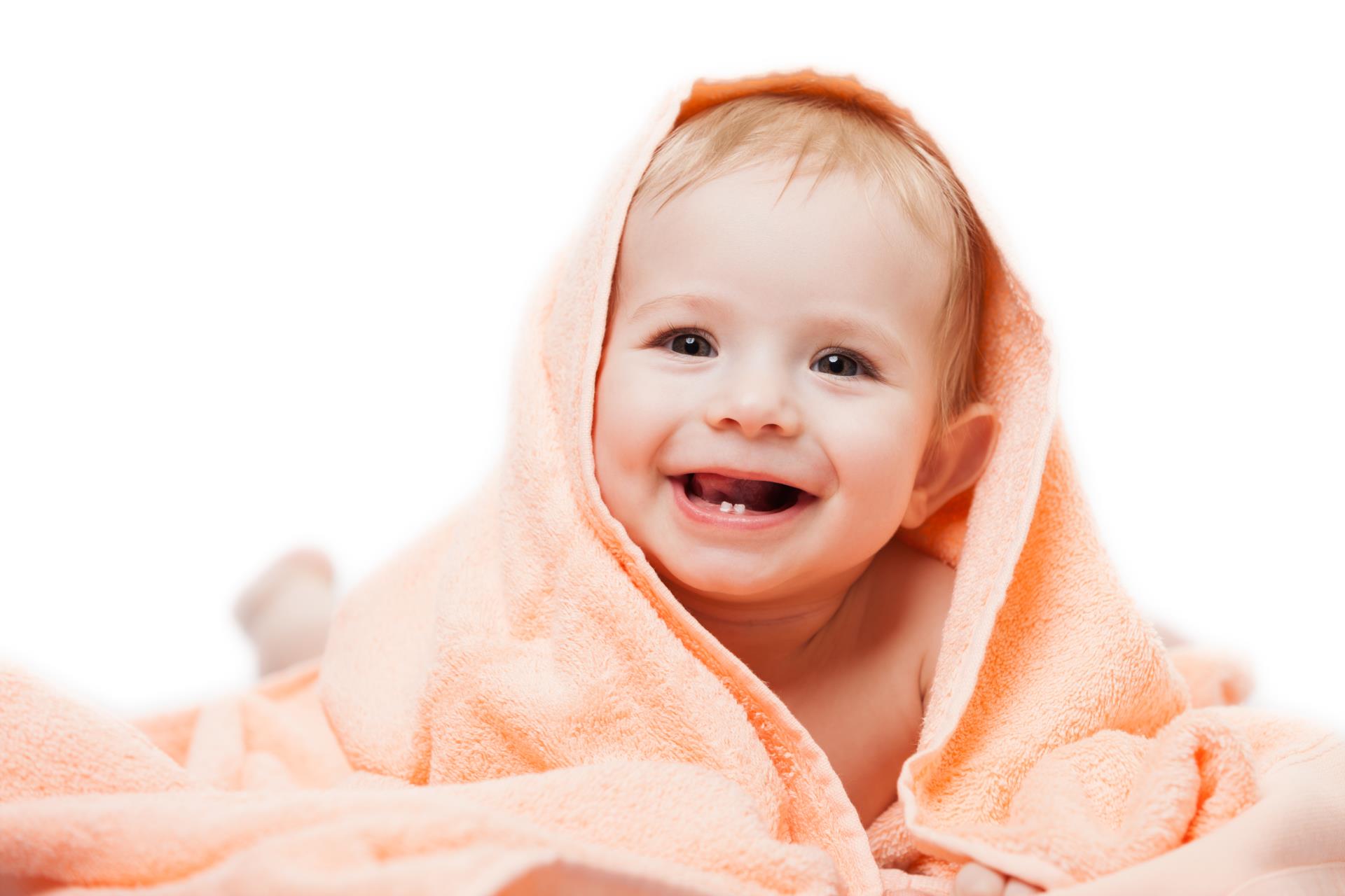 Happy baby with big smile showing off new bottom teeth